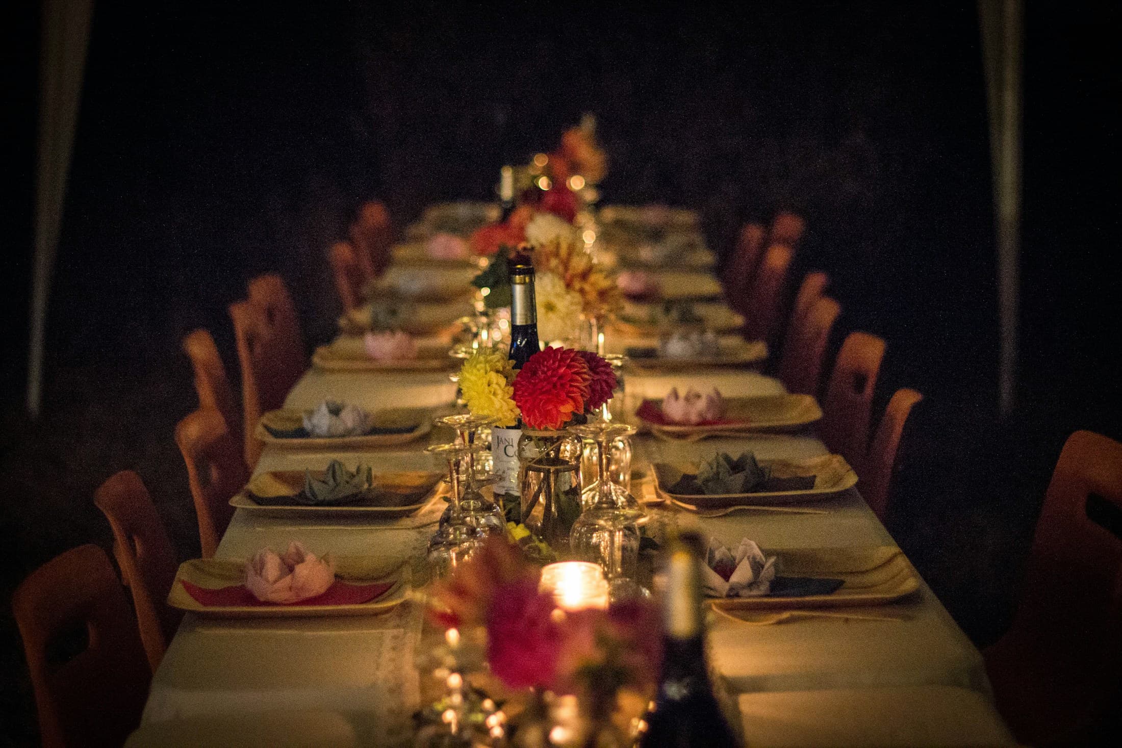 Friends sharing a candlelit dinner